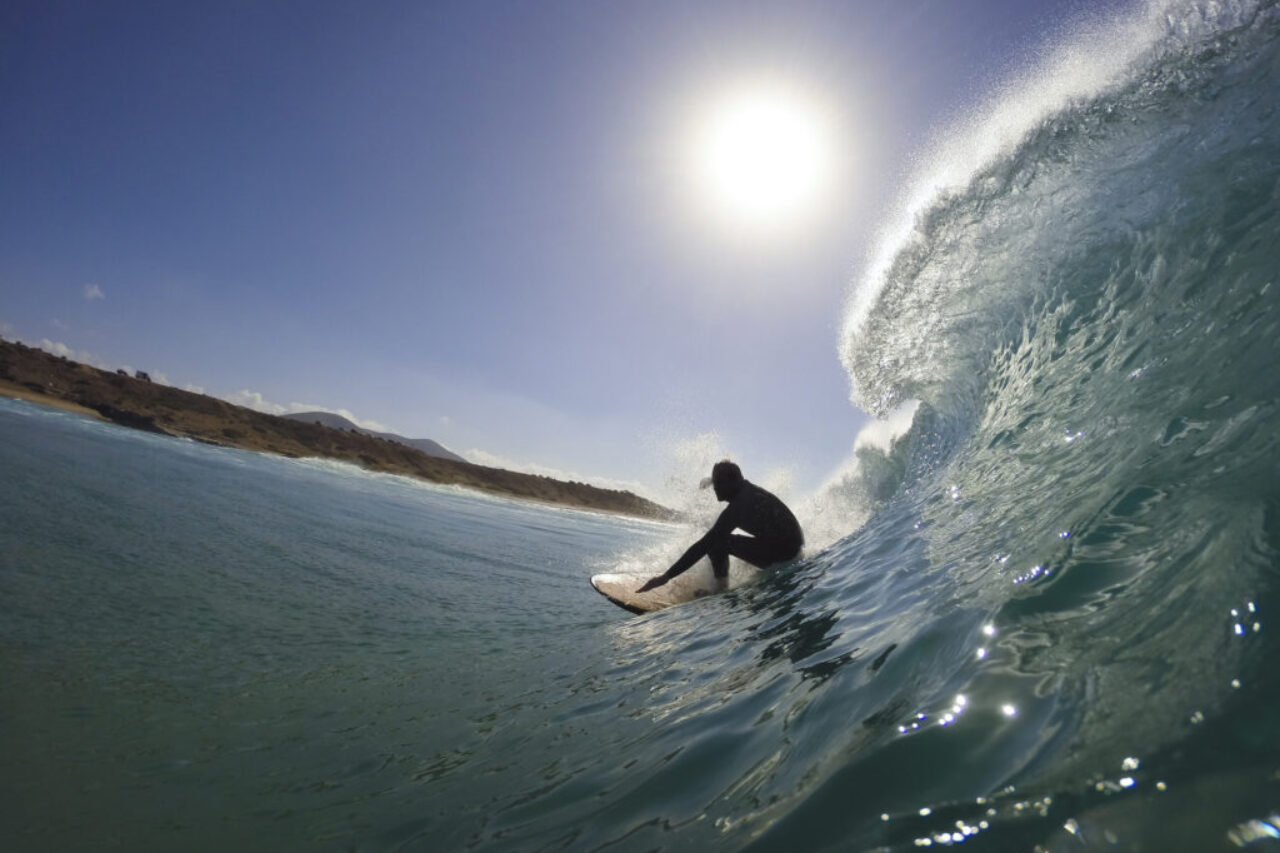 surfer in the tube of a wave by InsiderFuerteventura