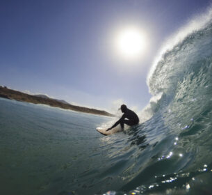 surfer in the tube of a wave by InsiderFuerteventura